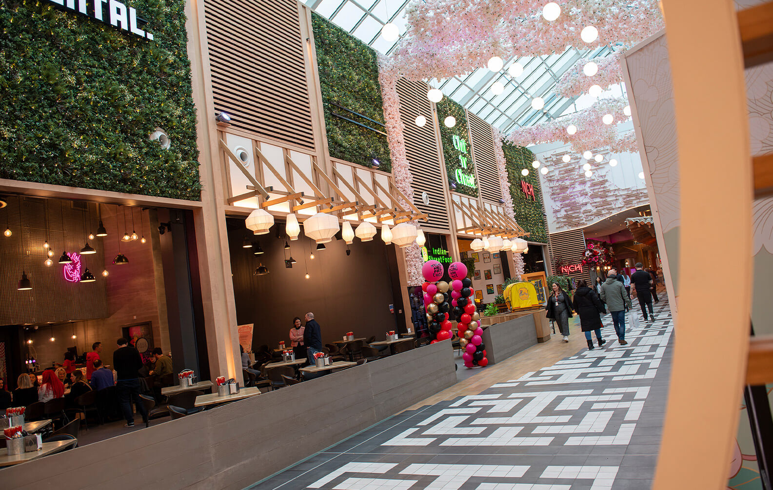 Trafford Centre Eastern Garden - Sculptform Click-on Battens and Acoustic Slat Wall create warmth between Garden Screen Panels and Blossom Features 